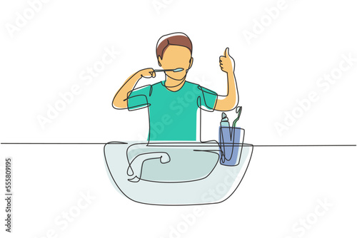 Single one line drawing man brushing his teeth with thumbs up gesture. Routine habits for cleanliness, health, freshness of mouth and teeth. Continuous line draw design graphic vector illustration