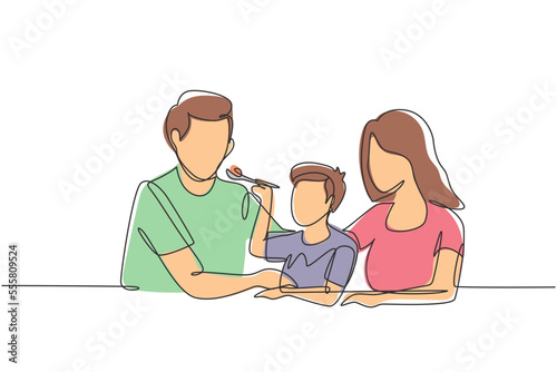 Continuous one line drawing young family having fun together in modern restaurant. Boy feeds his father with love. Happy little family concept. Single line draw design vector graphic illustration