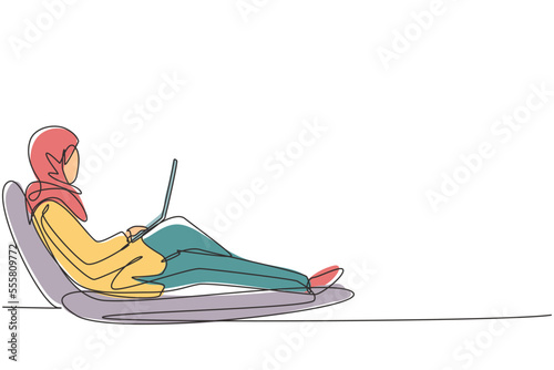 Single continuous line drawing Arabian female with laptop sitting on recliner chair. Freelance, distance learning, online courses, studying concept. One line draw graphic design vector illustration photo