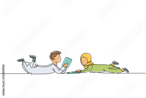 Single one line drawing two Arabian kids boy and girl reading, learning and laying down on the floor. Study at home. Smart students, education. Continuous line draw design graphic vector illustration