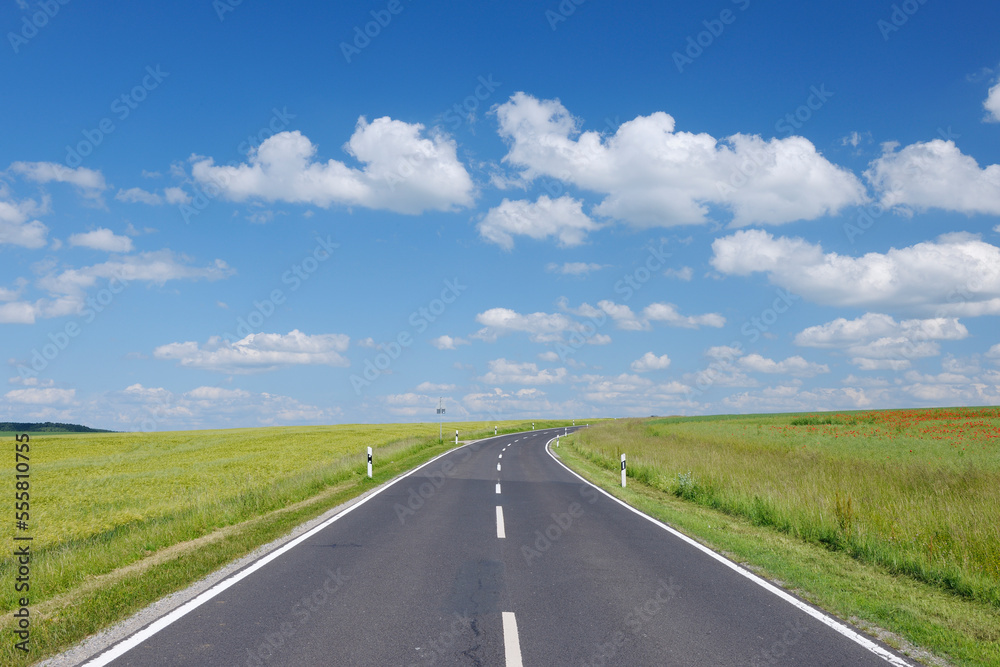 Road through fields with dramatic sky. Franconia, Bavaria, Germany. Road through fields with dramatic sky. Franconia, Bavaria, Germany.