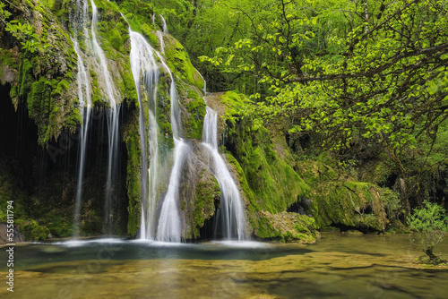 Waterfall cascading over green moss, Cascade des Tufs, Arbois, Jura, Jura Mountains, Franche-Comte, France photo