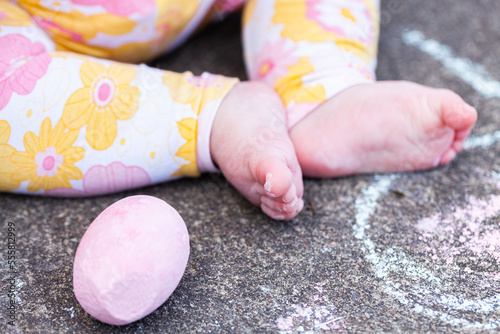 Chubby seven month old baby feet with chalk drawings on concrete - childhood photo