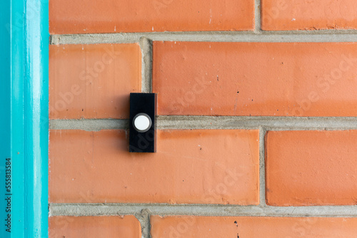 Doorbell on red brick house photo