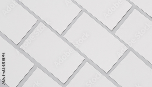 Many blank white business cards for branding on a gray background. Mockup for presentations  corporate identity and portfolios of graphic designers