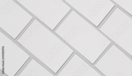 Many blank white business cards for branding on a gray background. Mockup for presentations, corporate identity and portfolios of graphic designers