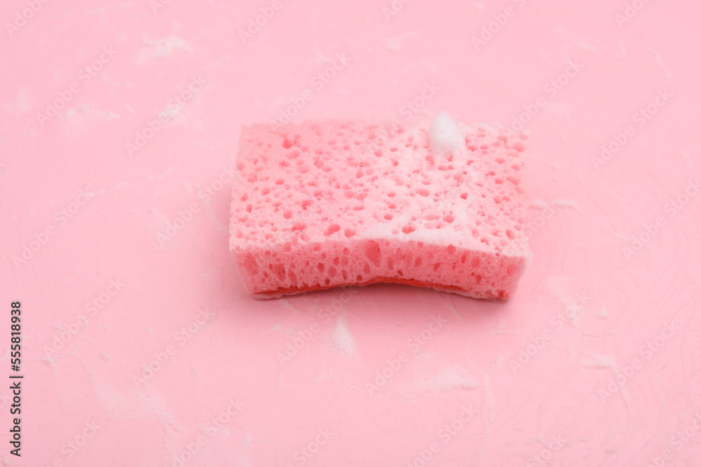 Sponge with foam on a pink background. Cleaning concept Sponge with foam on a pink background. Cleaning concept