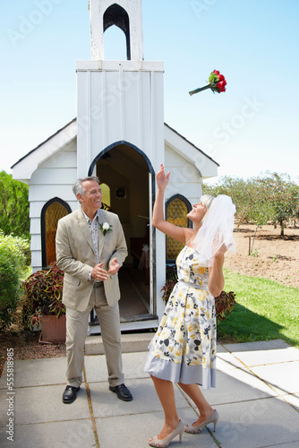 Bride Tossing Bouquet Outside Chapel, Niagara Falls, Ontario, Canada photo