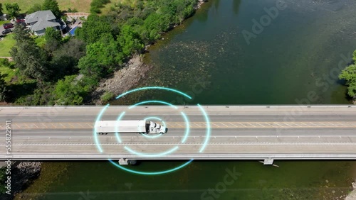 Self driving semi truck navigating a bridge to deliver its load. photo