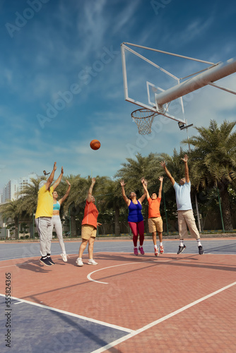Photography Family playing basketball together at basketball court.