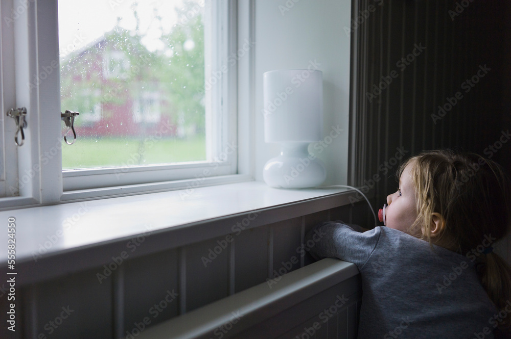 Young Girl Looking out of Window, Sweden Young Girl Looking out of Window, Sweden
