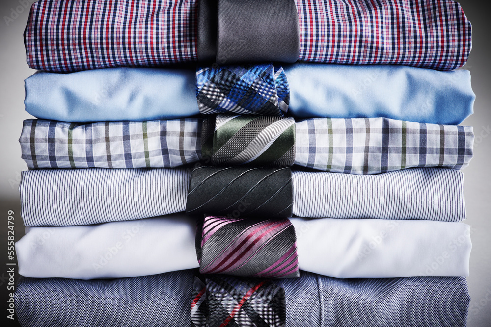 Close-up of stack of dress shirts with ties, studio shot Close-up of stack of dress shirts with ties, studio shot