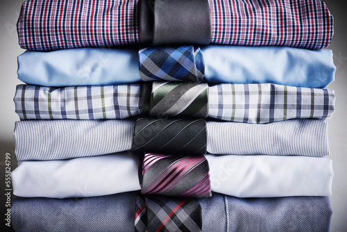 Close-up of stack of dress shirts with ties, studio shot photo