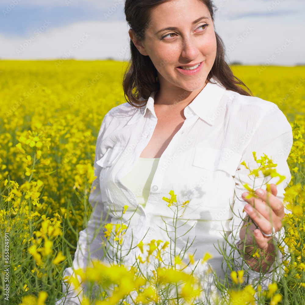 Woman Standing in Canola Field, Alberta, Canada Woman Standing in Canola Field, Alberta, Canada