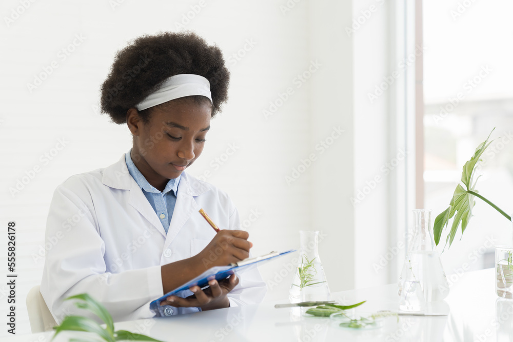 Young woman scientists learning and writing science and doing analysis for germs and bacteria with microscope in the laboratory. Science and education, researcher and discovery concept Young woman scientists learning and writing science and doing analysis for germs and bacteria with microscope in the laboratory. Science and education, researcher and discovery concept