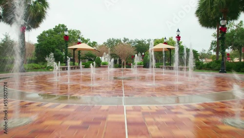 View inside the splash pad of the charming and quaint city of Downtown Winter Garden, Florida as a golf cart passes. photo