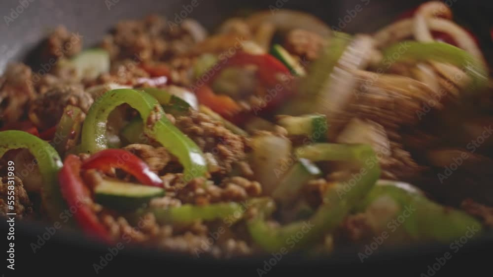Macro shot of meat and vegetables in a wok, cooking homemade mexican food. Macro shot of meat and vegetables in a wok, cooking homemade mexican food.