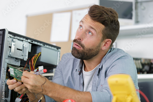 Принти на полотні a professional man repairing and assembling a computer