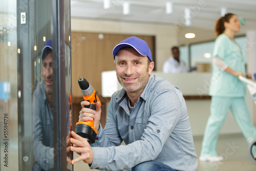 bearded man using hammer drill in a hospital © auremar