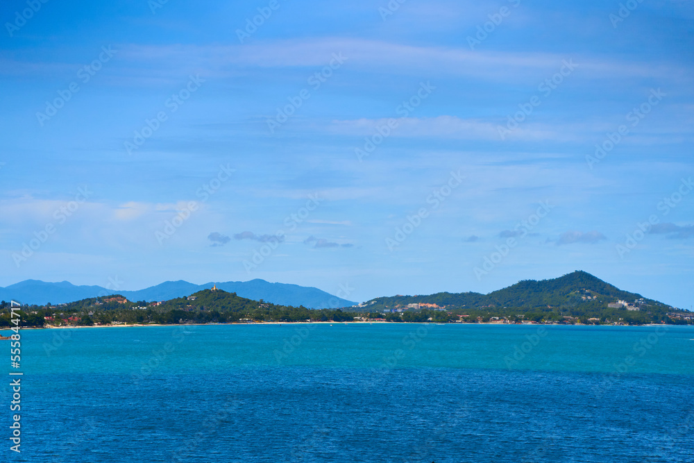 A seascape with turquoise water and islands in the distance. Winter vacation in Thailand