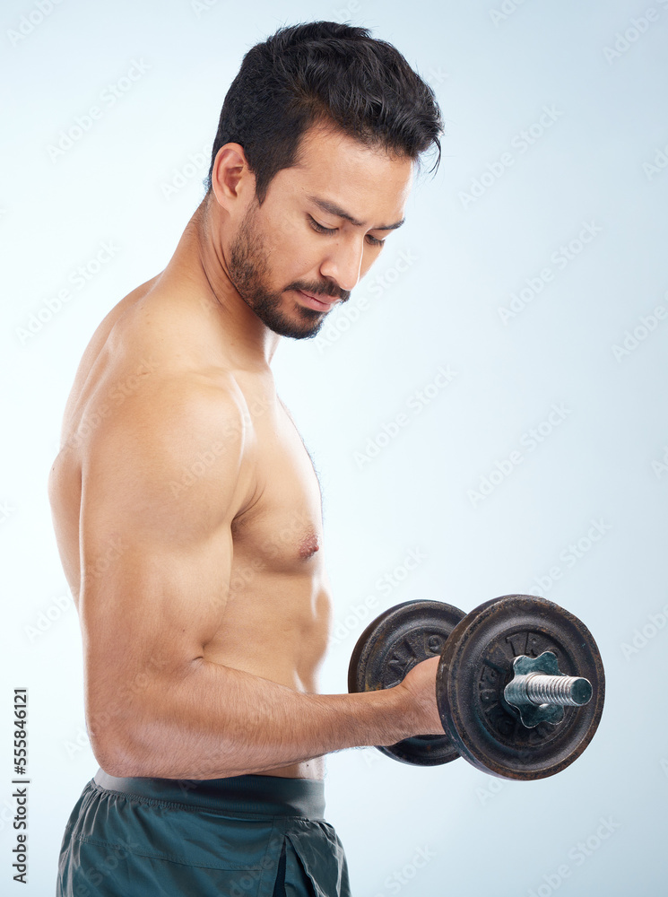 Man, fitness and dumbbell in studio for muscle, wellness and self care by blue background with focus. Model, bodybuilder workout and training for health, body or development with exercise by backdrop Man, fitness and dumbbell in studio for muscle, wellness and self care by blue background with focus. Model, bodybuilder workout and training for health, body or development with exercise by backdrop