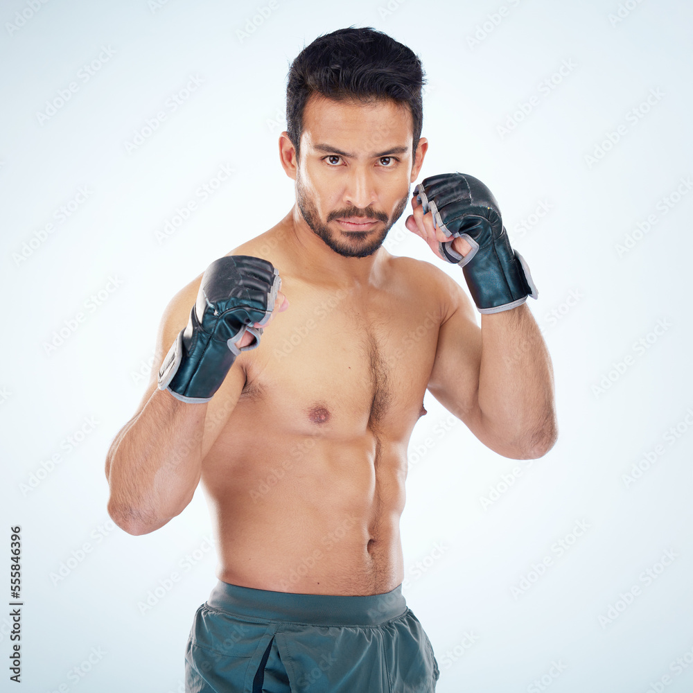 Face portrait, mma sports and man in studio on a blue background. Martial arts, body fitness and serious male fighter or boxer ready for training, workout or exercise for battle, match or competition Face portrait, mma sports and man in studio on a blue background. Martial arts, body fitness and serious male fighter or boxer ready for training, workout or exercise for battle, match or competition