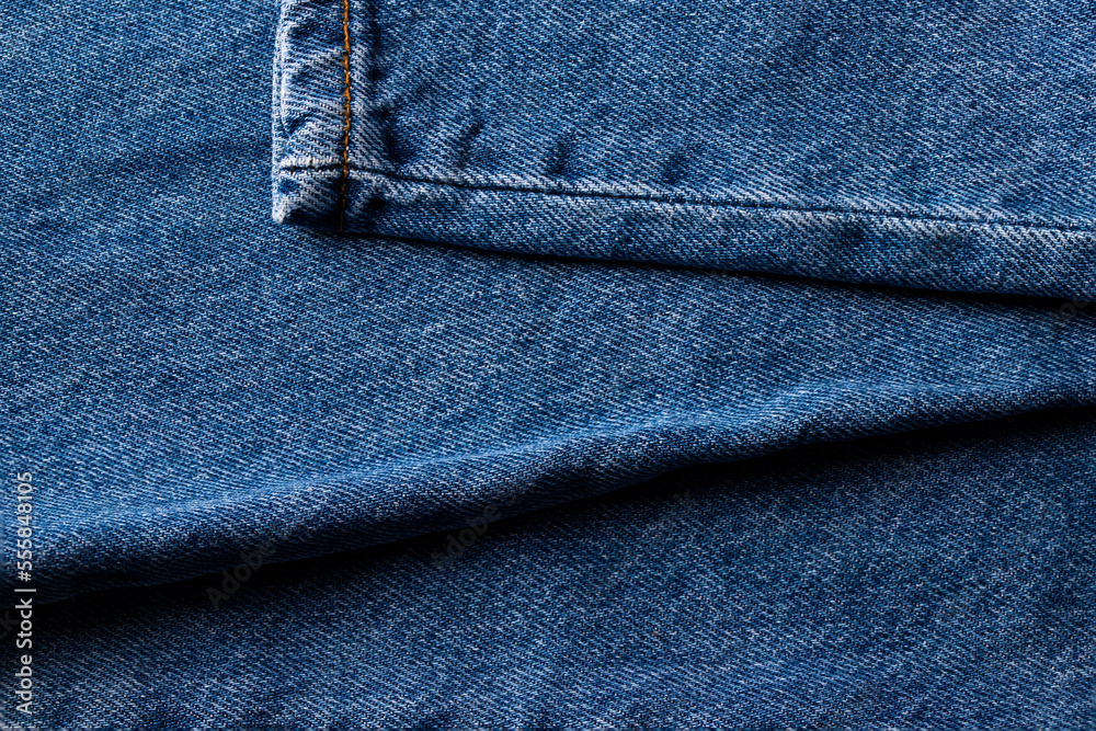 Blue jeans texture with a orange stich. Abstract denim cotton fabric Blue jeans texture with a orange stich. Abstract denim cotton fabric