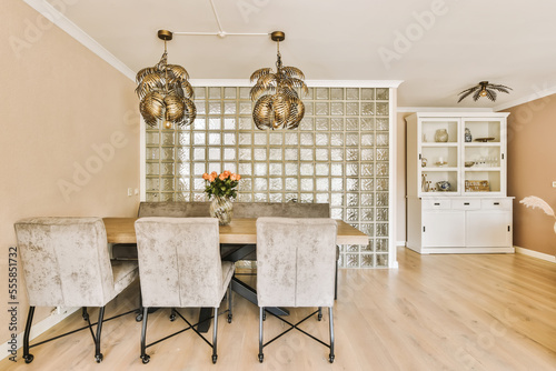 a dining room with chairs and a chandel in the middle of the room that is made out of glass blocks photo
