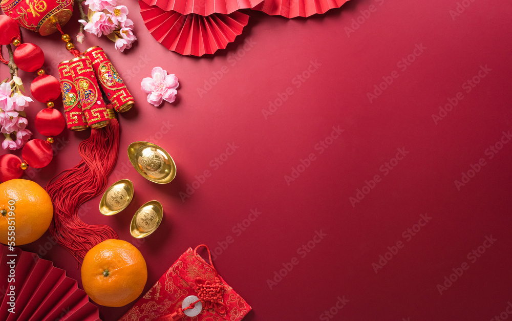 Chinese new year decorations made from red packet, orange and gold ingots or golden lump. Chinese characters FU on the object means to fortune, good luck, wealth, and money flow.