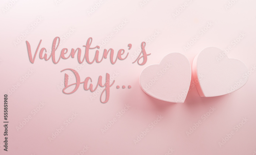 Happy valentine's day and love decoration background concept made from two hearts and the text on pastel pink background.