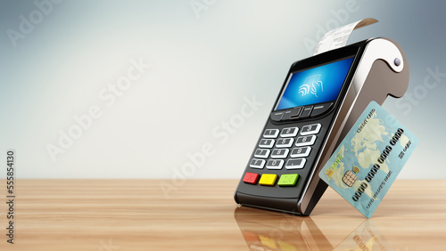 POS machine and credit card standing on wooden table. Copy space on the left side. 3D illustration photo