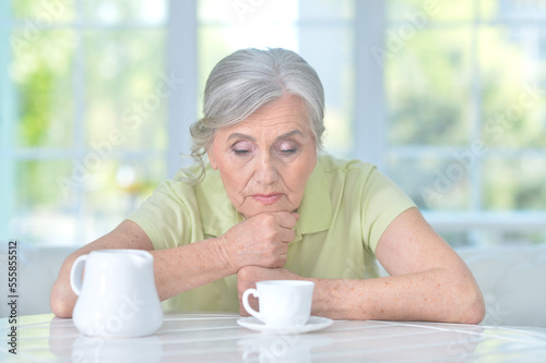 sad old woman drinking tea at home © aletia2011