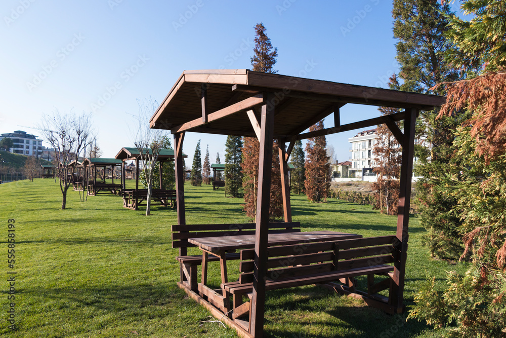 wooden arbor bench and table on the grass in the park wooden arbor bench and table on the grass in the park