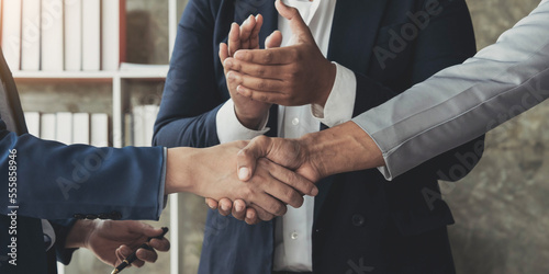 Business handshake for teamwork of business merger and acquisition,successful negotiate,hand shake,two businessman shake hand with partner to celebration partnership and business deal concept.