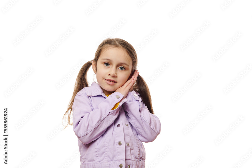 Isolated portrait on white background of a Caucasian cute baby girl, 5-6 years old child, smart school kid with two ponytails, wearing violet jacket, looking at camera. Copy space for advertising text Isolated portrait on white background of a Caucasian cute baby girl, 5-6 years old child, smart school kid with two ponytails, wearing violet jacket, looking at camera. Copy space for advertising text