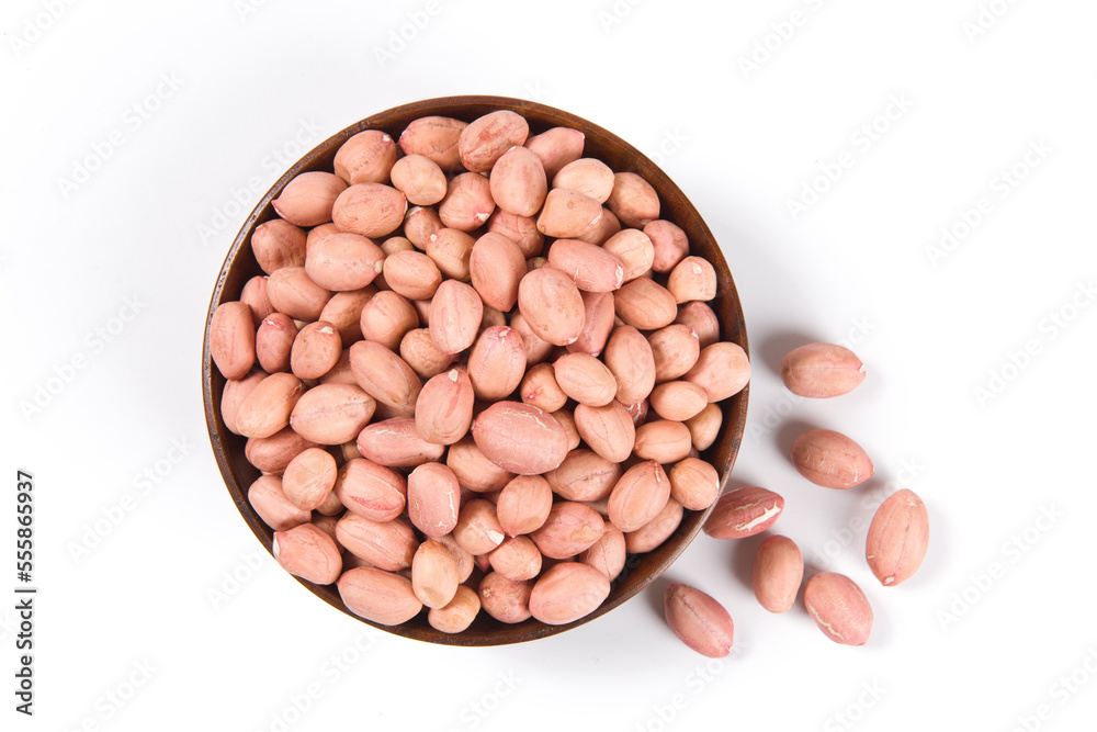 Raw peanuts in a wooden plate isolated on white background. Raw peanuts in a wooden plate isolated on white background.