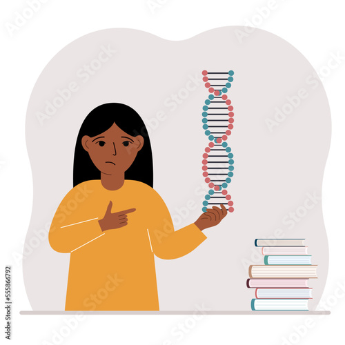 A little girl holds a DNA model in his hand and there are many books nearby.