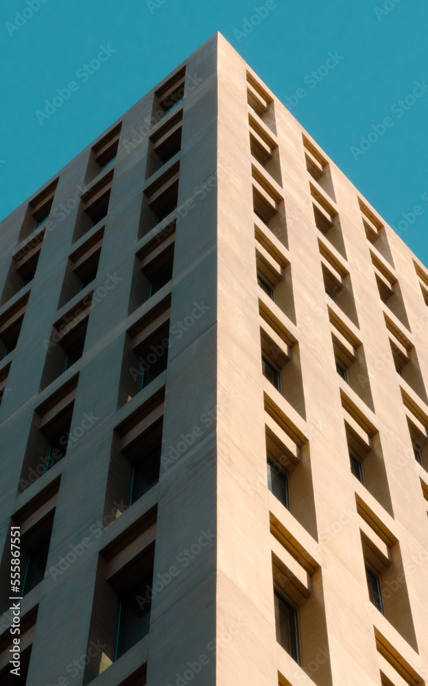 Low angle view of clean and minimalist modern office building like a pyramid in the city of justice. Low angle view of clean and minimalist modern office building like a pyramid in the city of justice.
