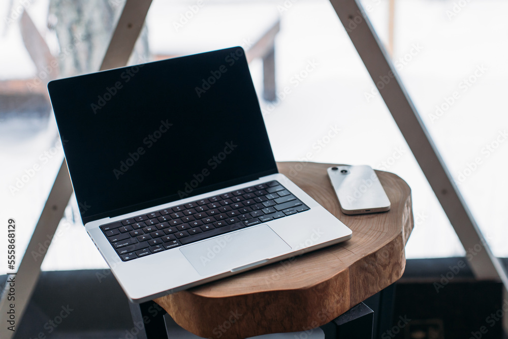 Fototapeta premium laptop on the table with space. winter outside the window
