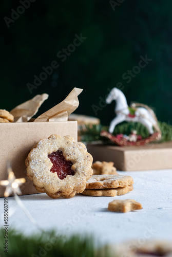 Shortcrust pastry Christmas cookies, Linzer cookies, biscuits with jam on the table.