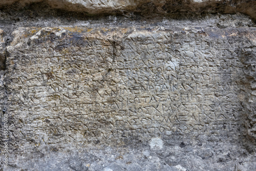 old roman text on the stone wall, Butrint, Albania