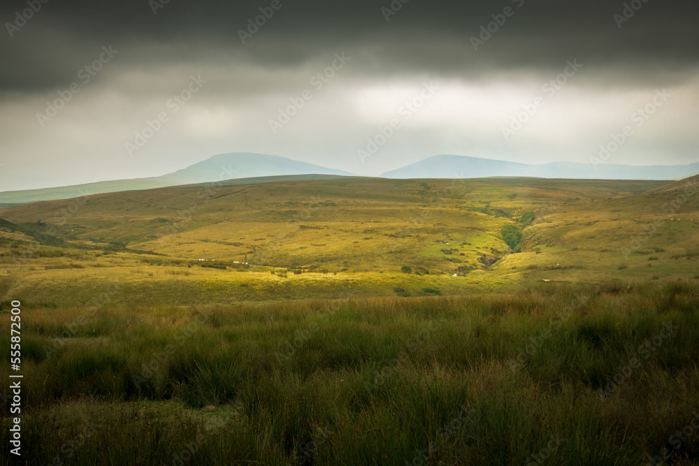 The moody landscape of the Brecon Beacons National Park in Wales, UK just beform a storm.