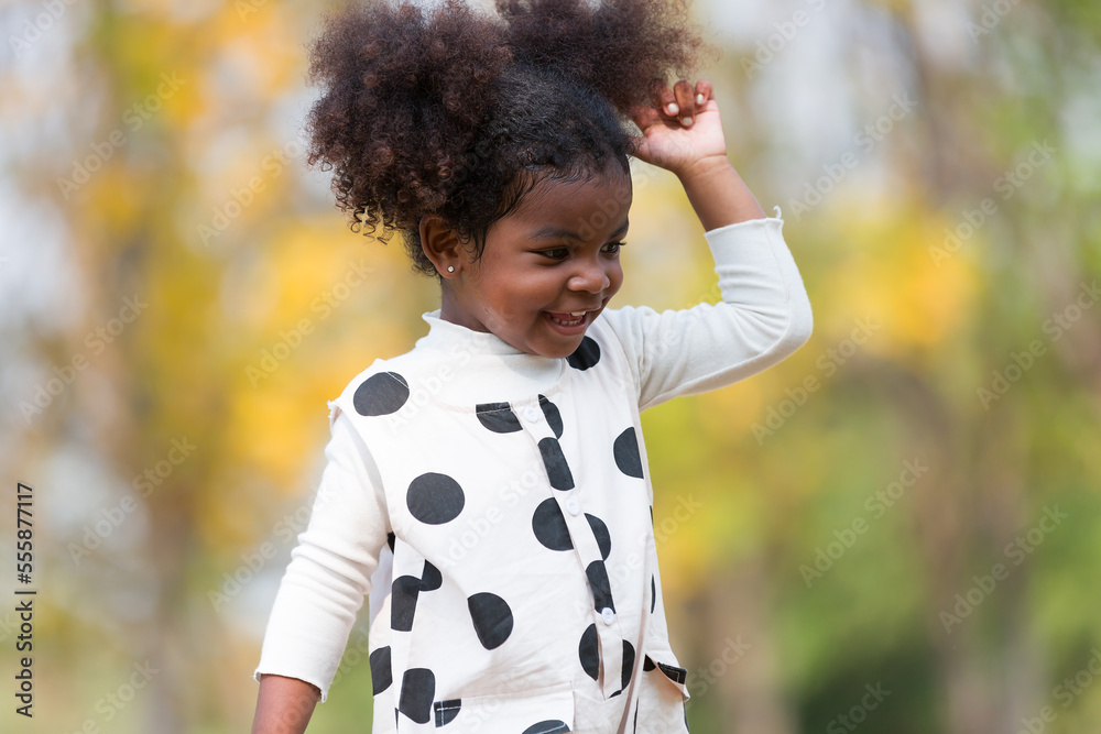 African American happy little girl playing outdoor in the park. Child girl having fun outdoors. Black kid people enjoying outside African American happy little girl playing outdoor in the park. Child girl having fun outdoors. Black kid people enjoying outside
