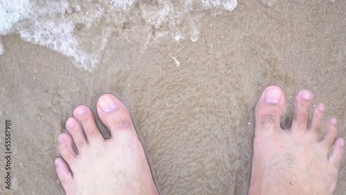 bare foot on beach sand with sea wave in carefree concept