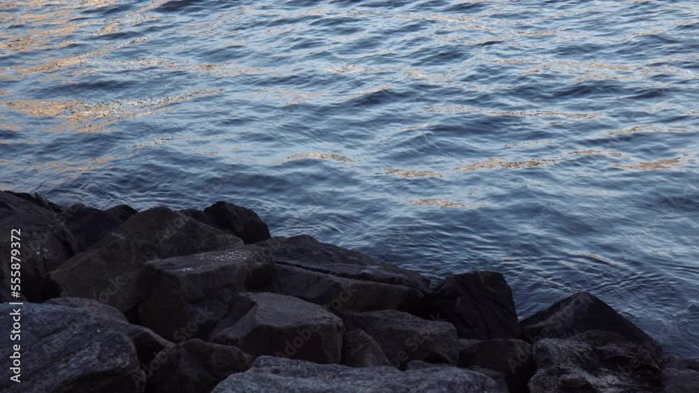 Water waves and ripples near man-made rocky coastline, USA, slow motion Water waves and ripples near man-made rocky coastline, USA, slow motion