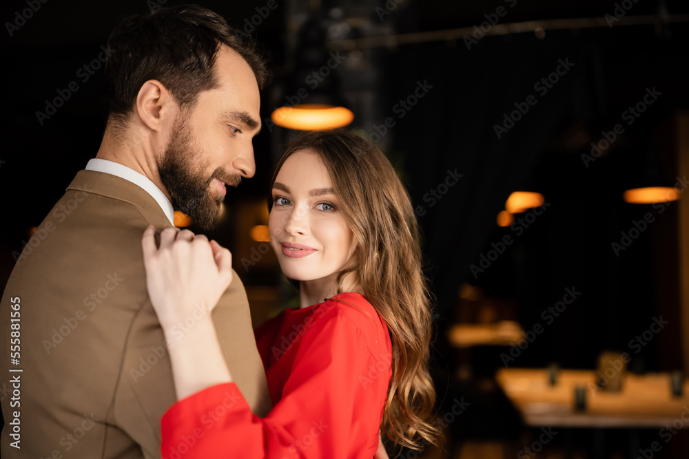 happy man and woman in festive attire hugging each other on valentines day