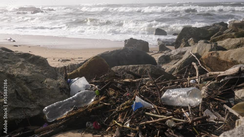 Plastic bottle garbage lying on Atlantic ocean sand beach in Portugal - environment nature pollution Plastic bottle garbage lying on Atlantic ocean sand beach in Portugal - environment nature pollution
