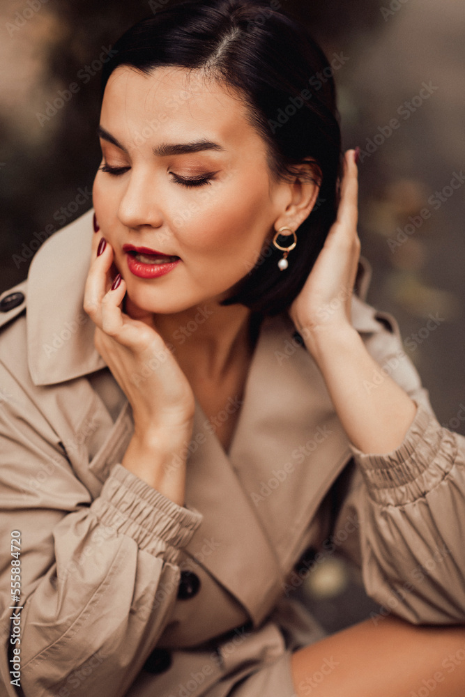 portrait of an attractive brunette in an autumn coat on a city street. portrait of an attractive brunette in an autumn coat on a city street.