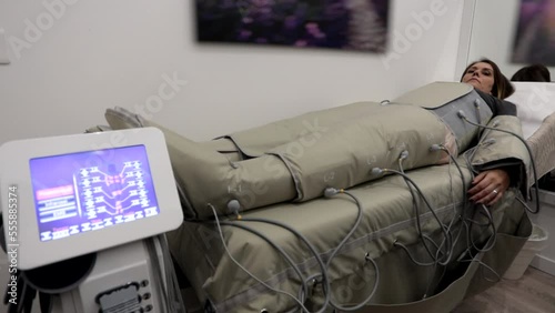 Woman receiving anti-cellulite pressotherapy procedure in beauty salon. Cellulite reducing treatment Pressotherapy and drainage procedure with lymphatic massage drainage machine.