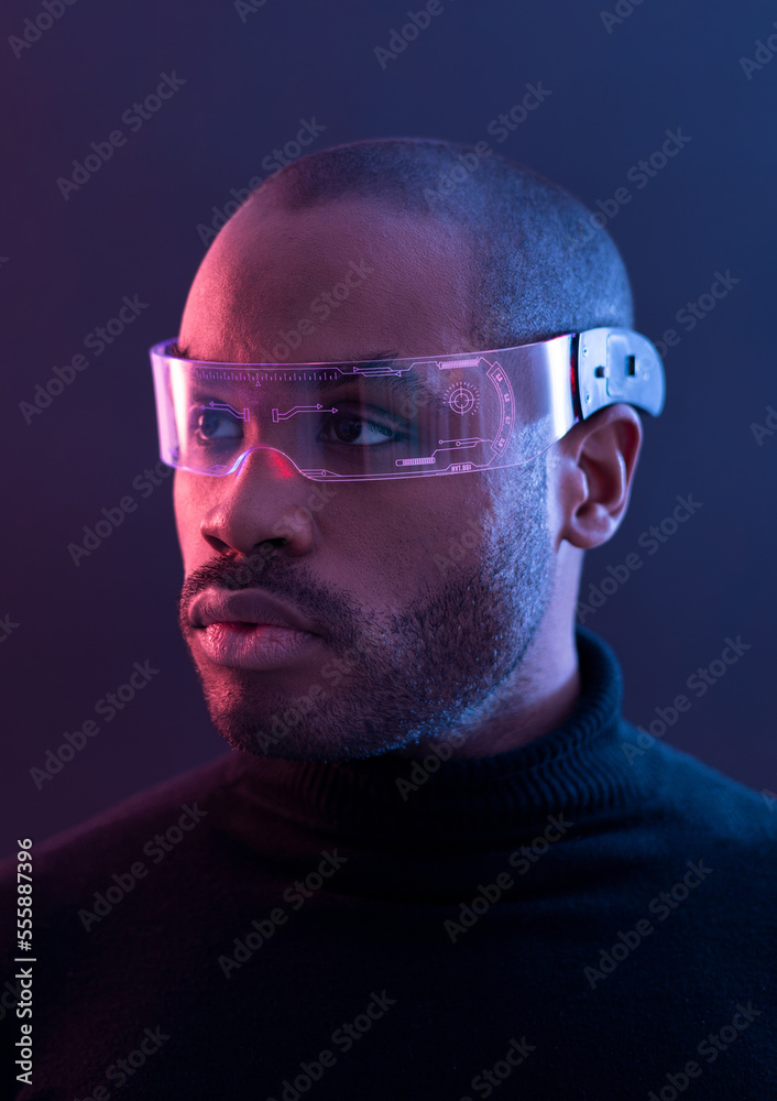 Portrait of a man with dark skin posing with led glasses in a studio with red and blue lights, smart glasses, Screen Glasses. Portrait of a man with dark skin posing with led glasses in a studio with red and blue lights, smart glasses, Screen Glasses.
